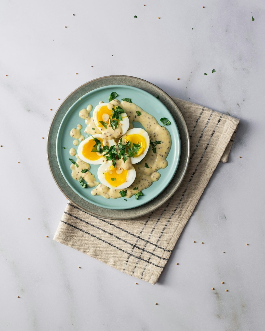 Creamy dill sauce with boiled egg and potatoes on a plate