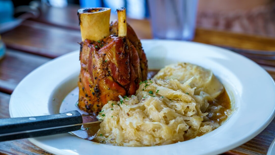 Roasted pork knuckle with dumplings and sauerkraut on a plate